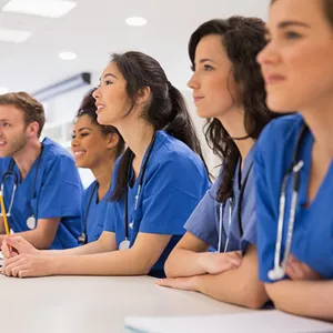 NURSES LINED UP SITTING IN A CLASSROOM