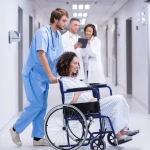 A nurse pushing a pregnant patient
