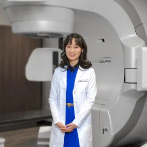 doctor in front of true beam equipment