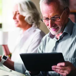 two people looking at their mobile tablets