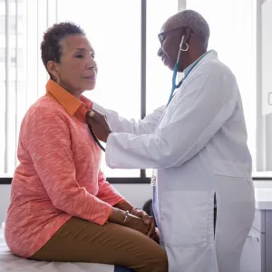 Doctor listening to patient heart