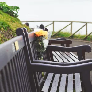 three benches with a flower bouquet in the middle