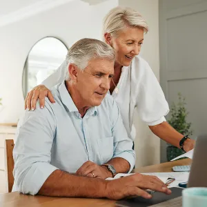 Two people looking at a laptop together