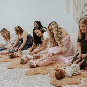 Mothers lined up with their babies for a class