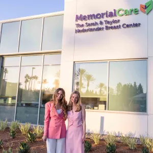 Two women standing in front of hospital