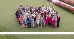 GROUP OF WOMEN STANDING ON GRASS