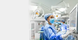 A surgeon clicking a monitor in the emergency room
