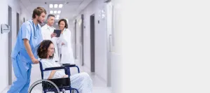 a nurse pushing a pregnant patient in a wheelchair