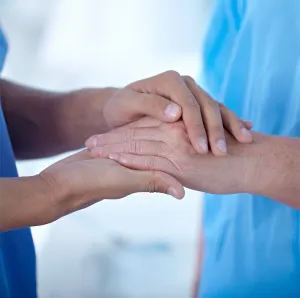 two individuals holding hands
