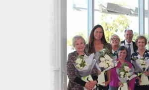 group of people holding flowers