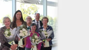 group of people holding flowers