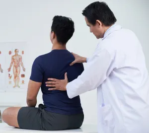 a doctor pressing against a patient back