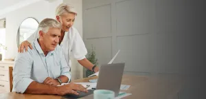 A man and a woman are looking at a computer